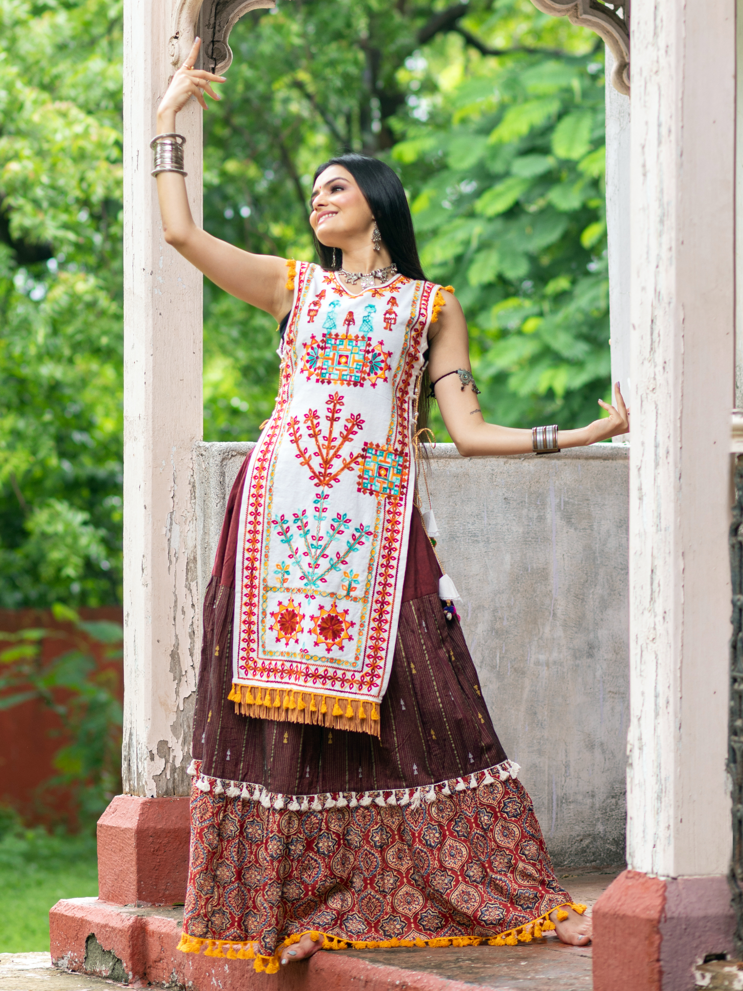 Off white dhingli motif embroidered panel top paired with wine trendy printed skirt