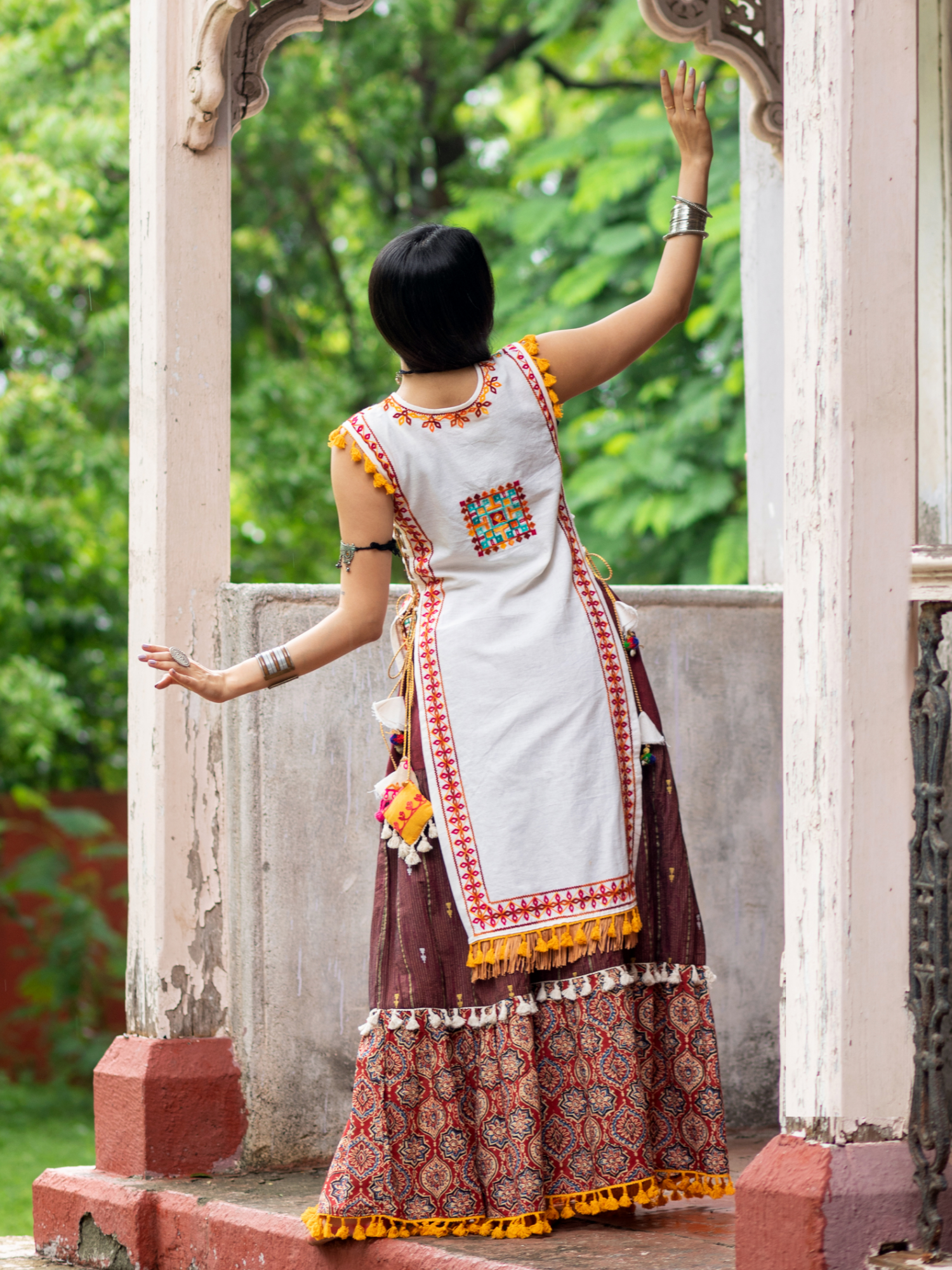 Off white dhingli motif embroidered panel top paired with wine trendy printed skirt