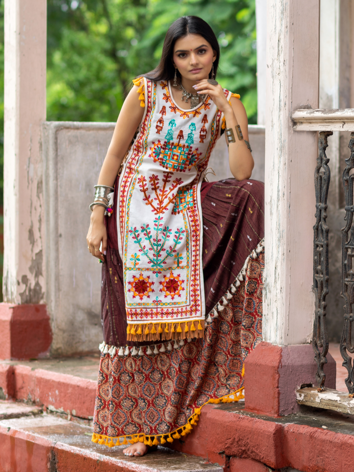 Off white dhingli motif embroidered panel top paired with wine trendy printed skirt